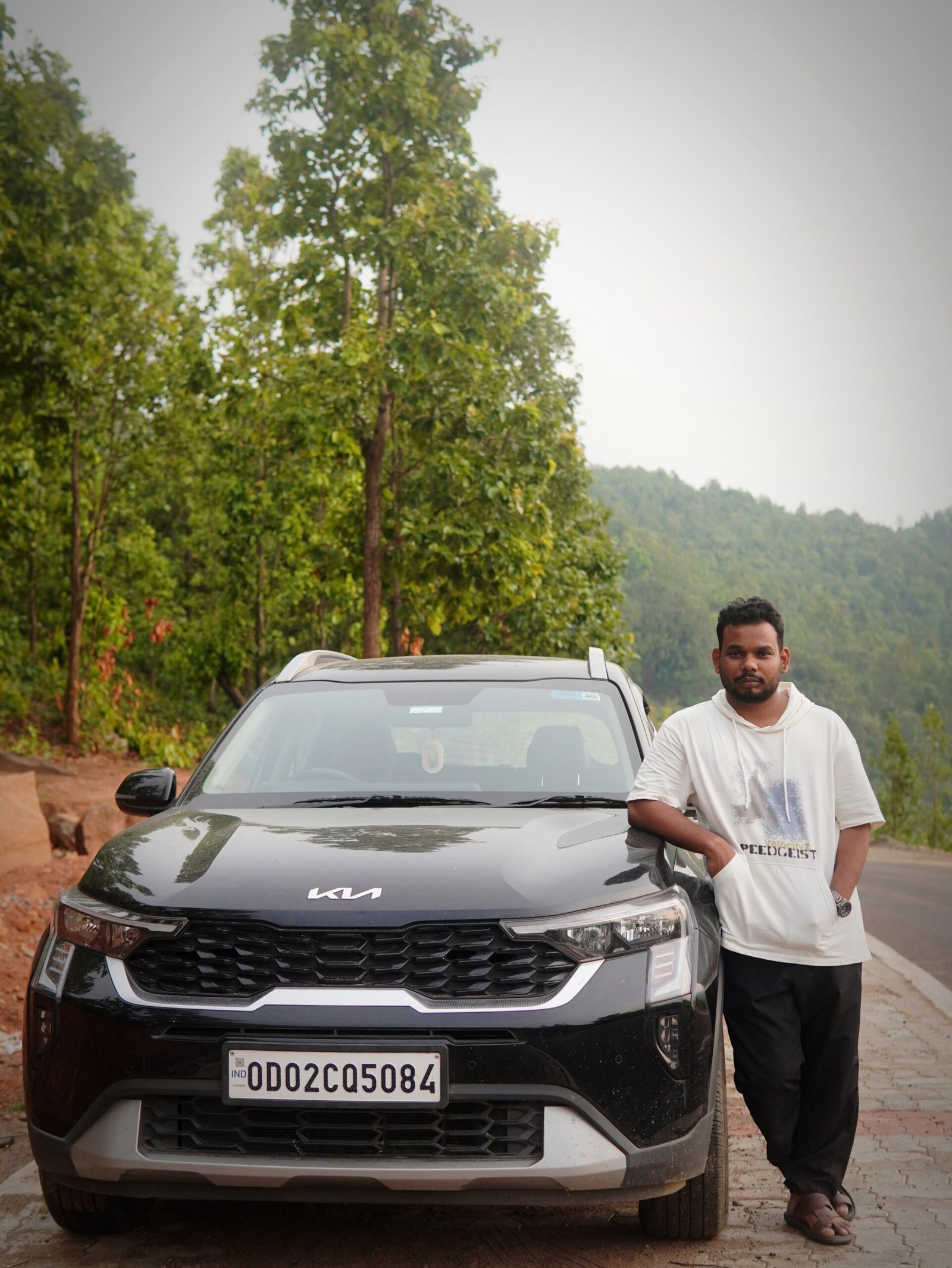 Rakesh overlooking misty mountains of Daringbadi, Odisha